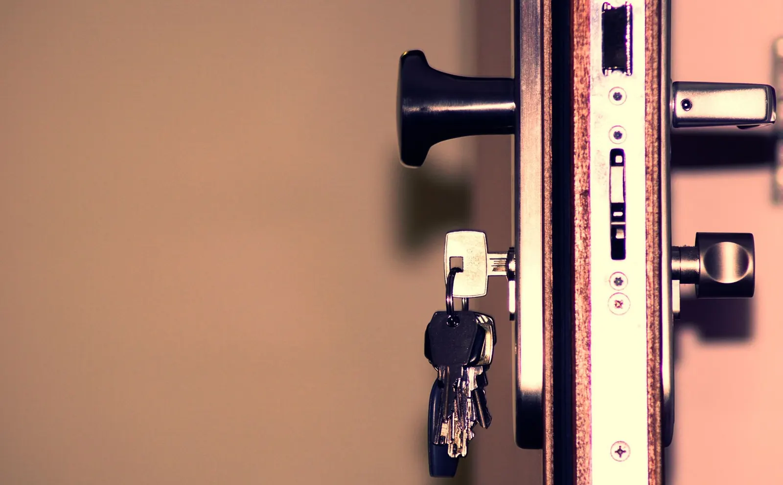 Keys hanging in an open door lock